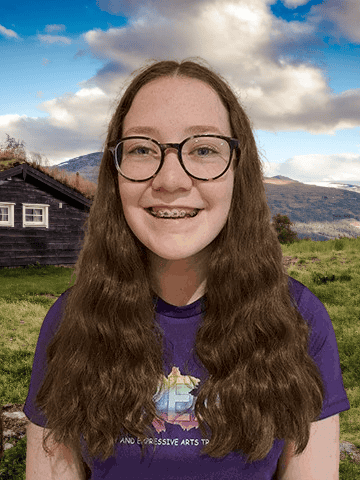 Young woman with Hillside Cottage in background