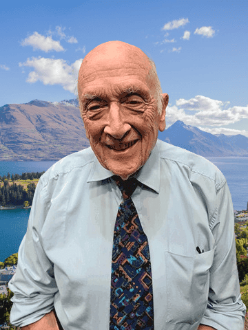 Man in blue shirt and tie with seas and hills background