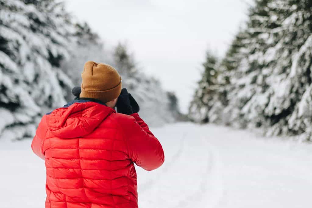 Person in orange jacket on a winter journey