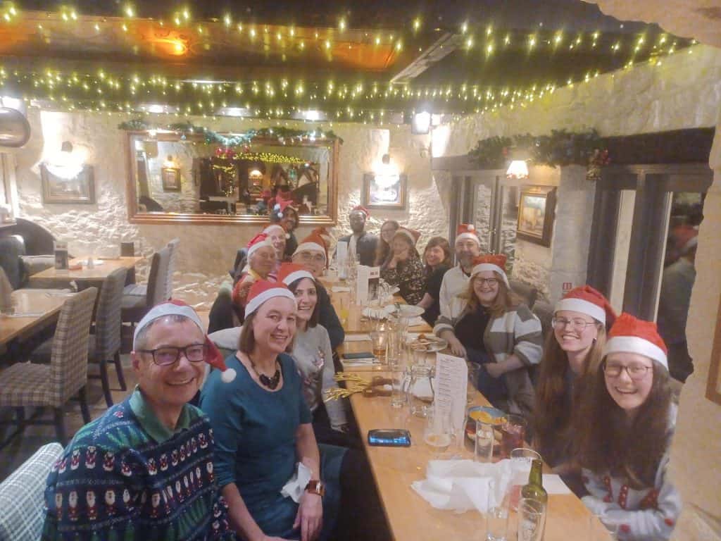 Choir members in Christmas-themed inn